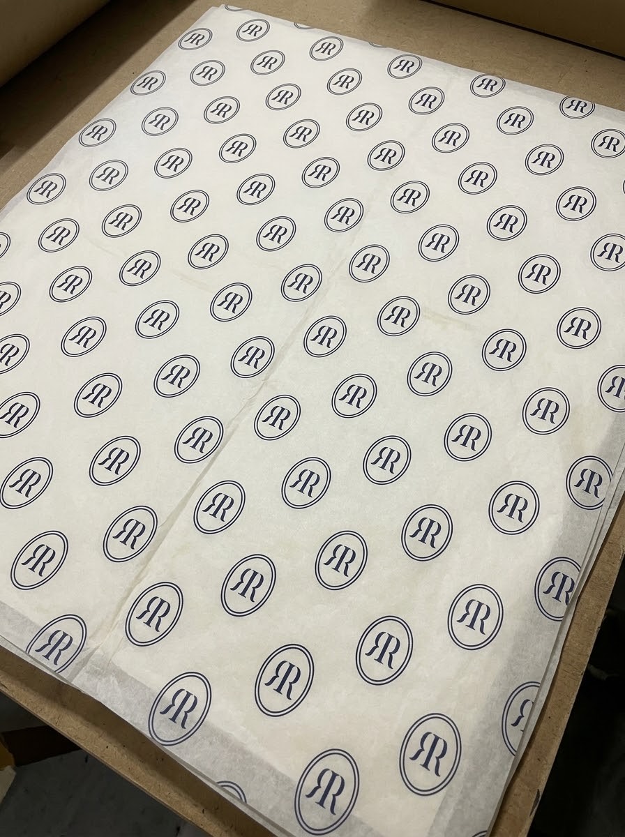 Ivory tissue paper printed with the RR monogram in navy ovals