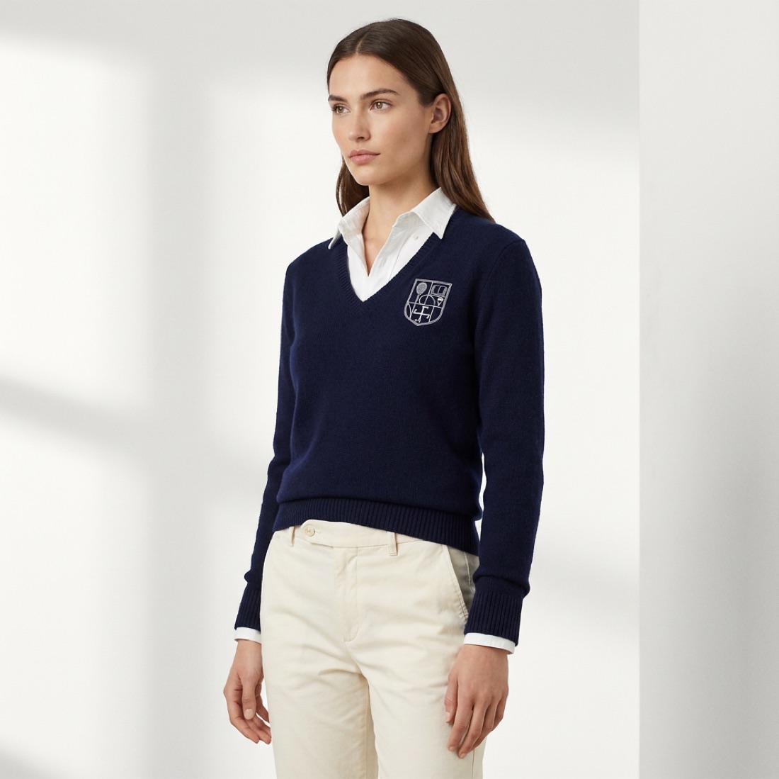 A model in the navy Crest V-Neck over a white shirt